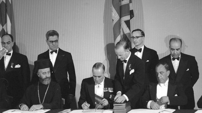 Kıbrıs Valisi Sir Hugh Foot (ortada), III. Makarios (solda) ve Dr. Fazıl Küçük, Kıbrıs Cumhuriyeti'nin Kuruluş Antlaşması'nı imzalıyor.