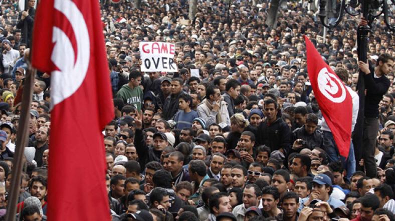 Tunus'ta protesto gösterilerinde kalabalıklar ve ülkenin bayrağı.